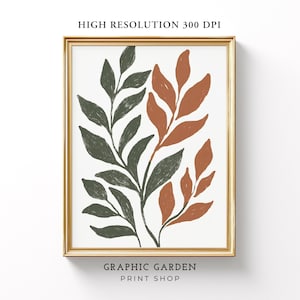 May include: A digital art print featuring a stylized illustration of two branches with leaves in shades of green and orange. The print is framed in a gold frame and has the text "GRAPHIC GARDEN PRINT SHOP" at the bottom.