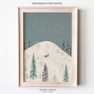May include: A framed illustration of a skier on a snowy mountain with a blue sky and white stars. The skier is wearing a yellow jacket and black pants. The mountain is covered in snow and has a winding path.