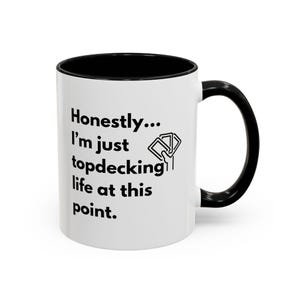 May include: White ceramic mug with a black rim and handle. The mug has black text that reads "Honestly... I'm just topdecking life at this point." and a black illustration of a hand drawing a card from a deck.