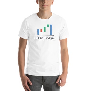 May include: White t-shirt featuring a blue, green and red bar chart design with the text "I Build Bridges".