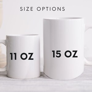 May include: Two white ceramic mugs, one 11 oz and one 15 oz, on a light wood surface.  The mugs are empty and ready to be filled with your favorite beverage.