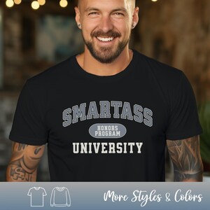 May include: A black t-shirt with the text "SMARTASS HONORS PROGRAM UNIVERSITY" in a gray, collegiate-style font.