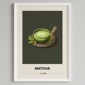 Könnte beinhalten: Eine grüne Schale mit Matcha-Tee, zwei Holzstäbchen und grünen Blättern auf einem braunen Untersetzer. Unter der Schale steht der Text "MATCHA" und "JAPAN".