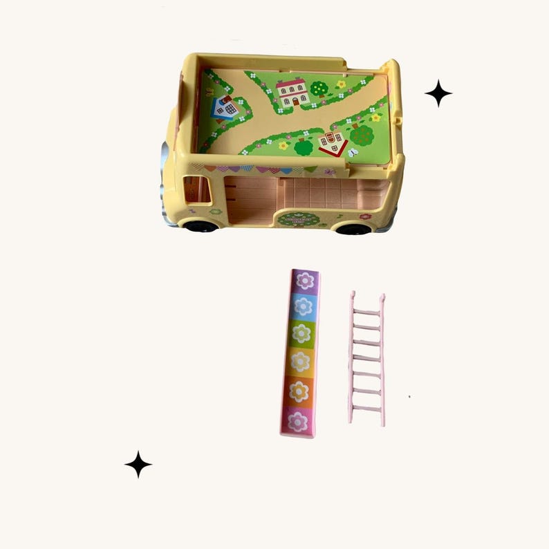 May include: A yellow toy bus with a colorful design on the roof and sides. The bus has a slide and a ladder that can be attached to the side.