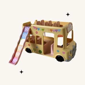 May include: A yellow double-decker bus toy with a slide attached. The bus has colorful flags and flowers on the side and says "Wonder Bus" on the back.
