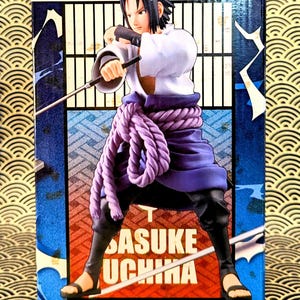 Pode incluir: Uma figura de Sasuke Uchiha da s&eacute;rie de anime Naruto. A figura est&aacute; em uma pose din&acirc;mica, vestindo uma parte superior branca, uma faixa roxa e cal&ccedil;as pretas. A caixa apresenta o nome do personagem e um fundo com arte em estilo japon&ecirc;s.