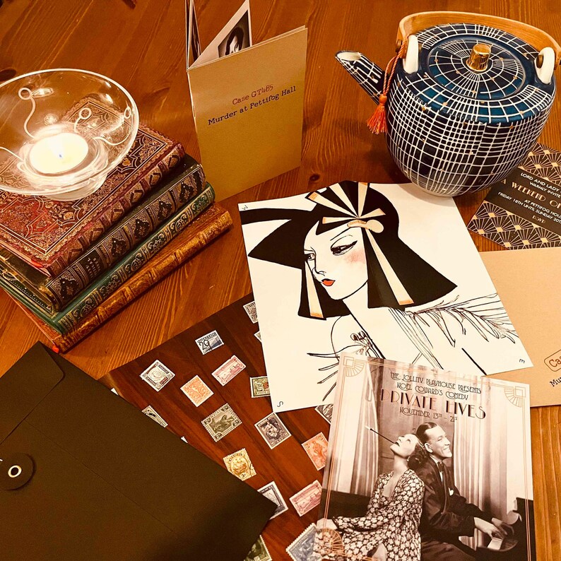 May include: A table top with a variety of items, including a stack of books, a teal blue teapot with gold accents, a black envelope, a brown card with the text "Case GT745 Murder at Pettifog Hall", a white card with a black and gold illustration of a woman's face, a white card with the text "The Jolly Playhouse Presents Noel Coward's Comedy Private Lives", and a brown card with gold and black geometric patterns.