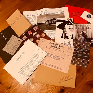 May include: A collection of papers and cards related to a murder mystery game. The papers include a newspaper article, a telegram, an invitation, and a note. The cards include a business card and a card with a drawing of a woman.