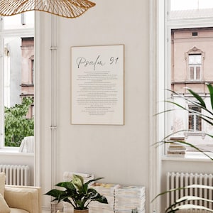Puede incluir: Un cuadro rectangular de pared que presenta el texto Psalm 91 en una fuente cursiva negra en la parte superior, seguido por el texto completo del pasaje b&iacute;blico en una fuente serif negra m&aacute;s peque&ntilde;a y clara sobre un fondo blanco, enmarcado en un marco dorado fino.