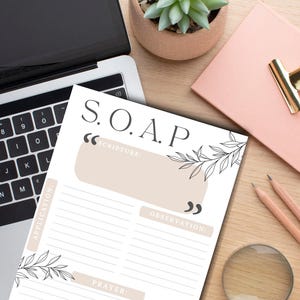 May include: A white printable worksheet with the acronym "S.O.A.P." in black text. The worksheet is divided into four sections: Scripture, Observation, Application, and Prayer. Each section has a line for writing. The worksheet is decorated with black line drawings of leaves.
