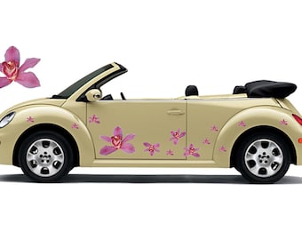 May include: A beige convertible car adorned with pink orchid flower decals. The car features black wheels and a black convertible top. A single orchid flower floats above the car.
