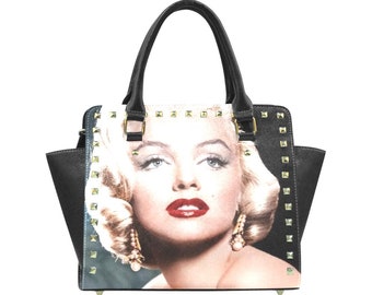 May include: Black handbag with gold studs and a print of Marilyn Monroe's face.