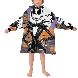 May include: A white hooded blanket with a colorful print of Jack Skellington from The Nightmare Before Christmas. The blanket has long sleeves and a large hood.