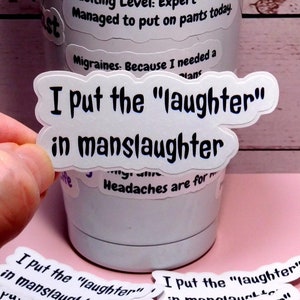 May include: A white tumbler with a variety of stickers on it. The stickers say "I put the "laughter" in manslaughter".