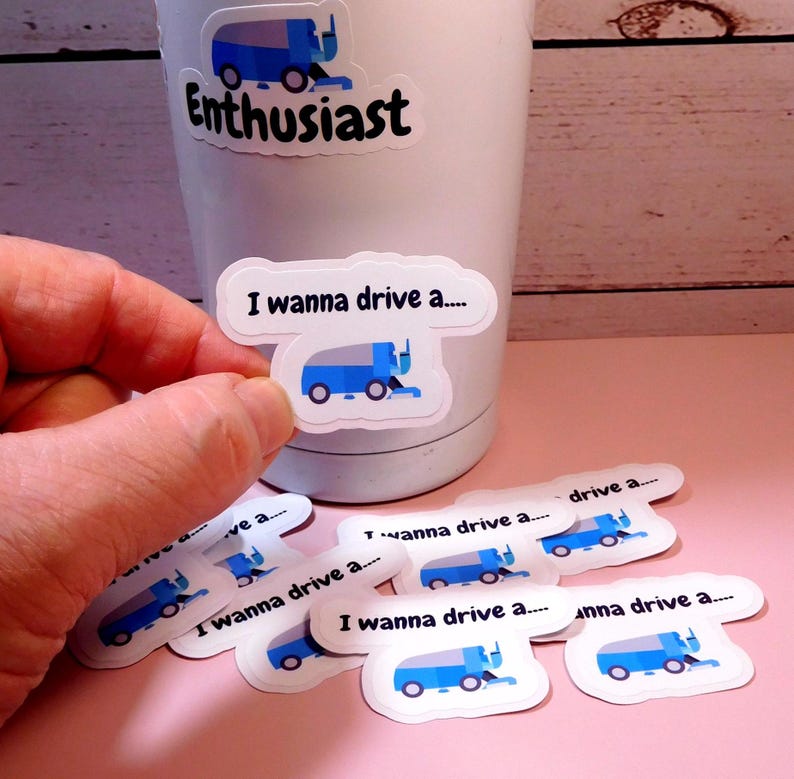 May include: A set of 8 white vinyl stickers featuring a blue street sweeper with the text "I wanna drive a..." on each sticker.