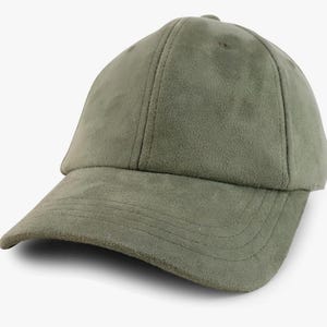 May include: A green suede baseball cap with a curved brim.