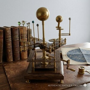 May include: An antique orrery model of the solar system, featuring brass components and a wooden base. The model includes a large golden sphere representing the sun, with smaller spheres depicting planets. The model is displayed on a wooden desk with antique books and a star chart.