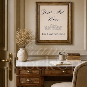 May include: A framed print with the text "Your Art Here" and size options, hanging above a vintage desk. The desk has a marble top, woven drawer fronts, and a chair. A vase with dried flowers sits on the desk.