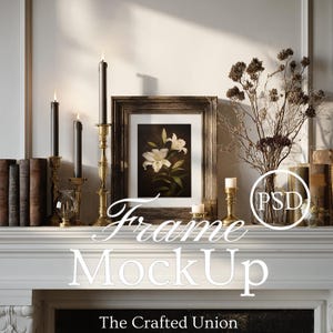 May include: A framed floral print with a dark wooden frame sits on a white mantelpiece. Black candles in gold candle holders and a glass vase with dried flowers are also on the mantelpiece. The text "Frame MockUp" is displayed.