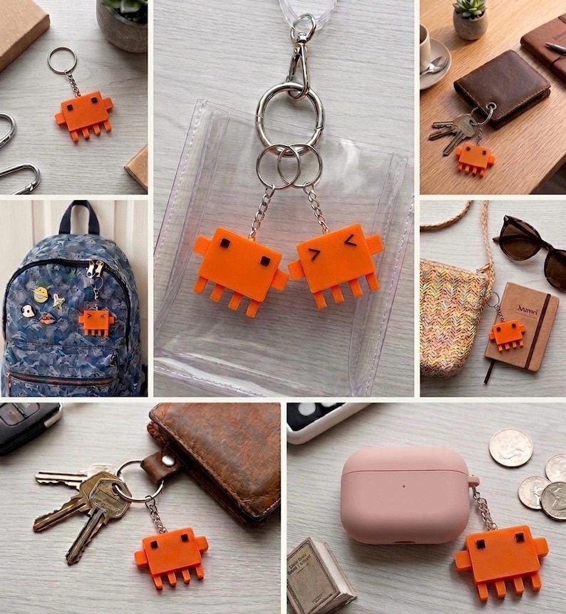 A collage of nine images shows the orange, pixelated crab-like keychain attached to various items like backpacks, keys, lanyards, and a wallet.