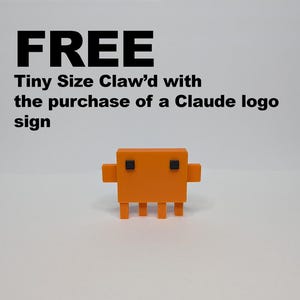 A small, orange, blocky, pixelated figure with two black square eyes is centered on a white background, with text above it reading "FREE Tiny Size Claw'd with the purchase of a Claude logo sign."