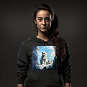 May include: A black hoodie featuring a printed design of three snow leopards sitting on a rock in a snowy mountain landscape.