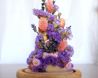 Dried and preserved flower on glass dome, beige/purple color
