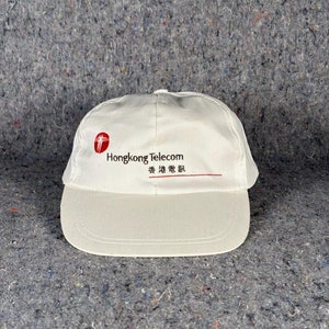 May include: White baseball cap with the logo "Hongkong Telecom" and the text "香港電訊" in red.