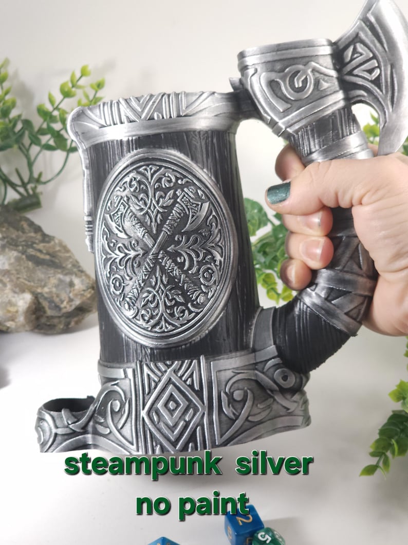May include: Steampunk silver tankard with an axe handle and intricate details. The tankard is made of metal and has a wood-like texture. The text "steampunk silver no paint" is visible below the tankard.