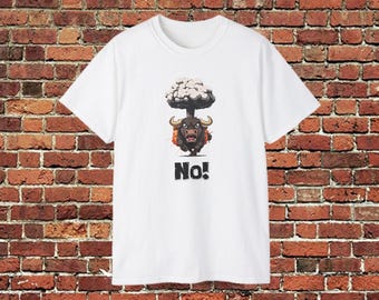 May include: White t-shirt featuring a cartoon bull with a mushroom cloud above it. The bull has horns and a determined expression. Below the bull, the word "No!" is printed in bold, black letters. The shirt is displayed against a brick wall.