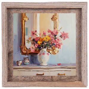 May include: A framed oil painting of a bouquet of pink and yellow flowers in a white vase with a floral pattern. The vase is on a white table with two small decorative jars. The painting is set against a light blue background.