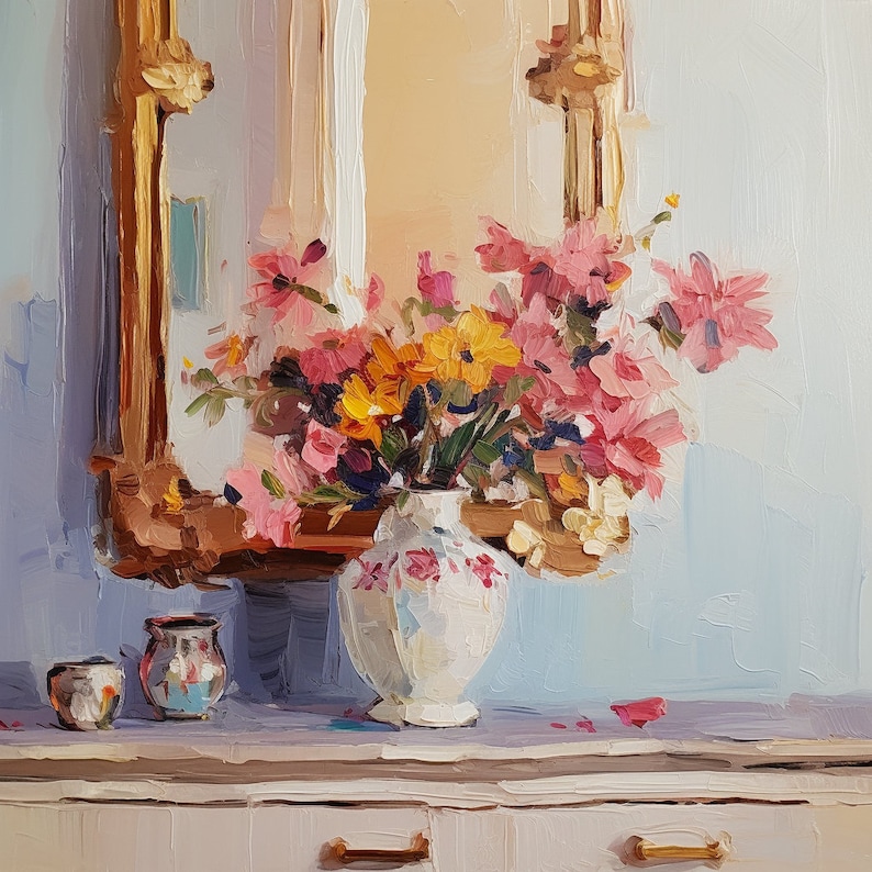 May include: A white ceramic vase with pink and yellow floral designs holds a bouquet of pink, yellow, and white flowers. The vase is sitting on a white countertop in front of a gold-framed mirror.