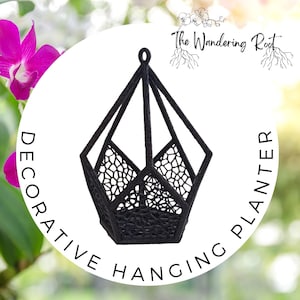 May include: Black geometric hanging planter with a delicate, web-like design. The planter is labeled "Decorative Hanging Planter" and "The Wandering Root".