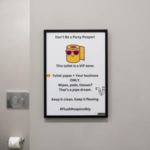 May include: A framed sign with the text "Don't Be a Party Pooper!" and a cartoon roll of toilet paper wearing sunglasses. The sign also includes the text "This toilet is a VIP zone: Toilet paper + Your business ONLY."
