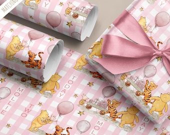 May include: Pink and white gingham wrapping paper featuring Winnie the Pooh, Tigger, and Piglet. The design includes balloons, stars, and the text "TWO MOLLIE TODAY". A gift is wrapped with a pink satin bow.