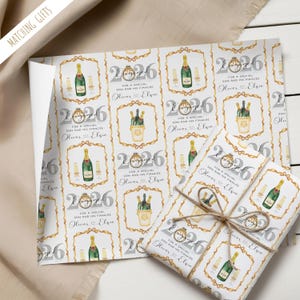 May include: Wrapping paper with a repeating pattern of champagne bottles, glasses, and the text "2026 For a special son and his fiancee Oliver & Elsie". The wrapped gift is tied with twine.