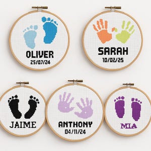 May include: Five round embroidery hoops with baby footprints and handprints in various colors. Each hoop has a name and date stitched below the design. The names are Oliver, Sarah, Jaime, Anthony, and Mia.