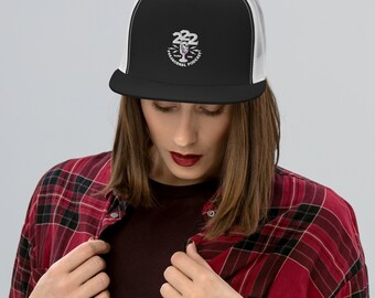 May include: Black and white trucker hat with a white mesh back. The hat features a white embroidered design with the text "222 Paranormal Podcast".