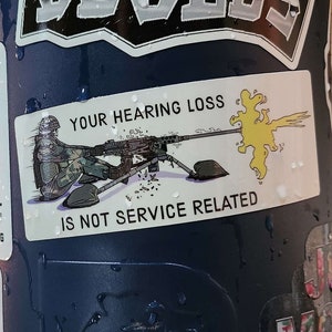 May include: A blue reusable water bottle with various stickers, including one that says "Your Hearing Loss Is Not Service Related" and a cartoon image of a soldier with a gun.