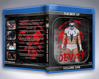 May include: A blue Blu-ray case with a black and red image of a wrestler wearing a white mask and white wrestling trunks. The text "THE BEST OF PRINCE DEVITT VOLUME ONE" is printed on the case.