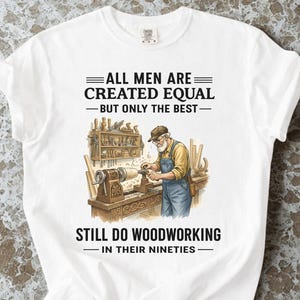 May include: White t-shirt with the text "ALL MEN ARE CREATED EQUAL - BUT ONLY THE BEST - STILL DO WOODWORKING - IN THEIR NINETIES." The shirt features an illustration of a woodworker at a lathe. The word "White" is at the bottom.