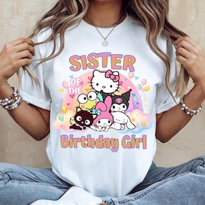May include: White t-shirt featuring a colorful graphic with the text "SISTER OF THE Birthday Girl" and several cartoon characters. The design includes a rainbow, balloons, and hearts.