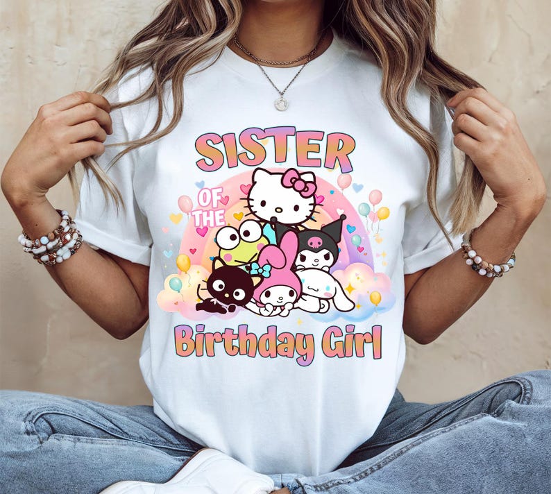 May include: White t-shirt featuring a colorful graphic with the text "SISTER OF THE Birthday Girl" and several cartoon characters. The design includes a rainbow, balloons, and hearts.