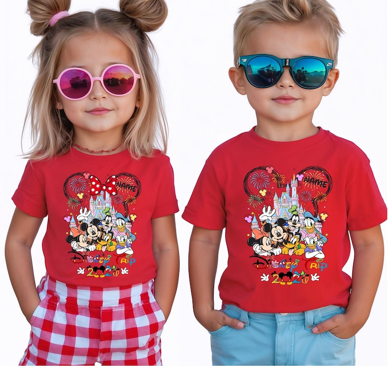 May include: Two children wearing red t-shirts with a Disney graphic. The shirts feature Mickey Mouse, Minnie Mouse, Donald Duck, and Goofy in front of a castle, with the text "Disney 2020 RIP". The girl wears pink sunglasses and the boy wears blue sunglasses.