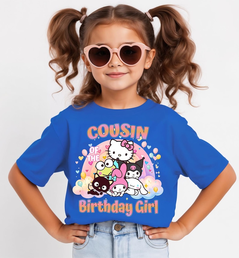 May include: A blue t-shirt with the text "COUSIN OF THE BIRTHDAY GIRL" and a graphic of cartoon characters. The girl in the image is wearing pink heart-shaped sunglasses.