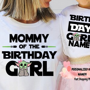 May include: Two white t-shirts with a green alien character. The larger shirt says "Mommy of the Birthday Girl" with a green lightsaber. The smaller shirt says "Birth Day Girl Name".