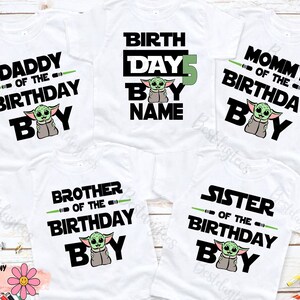 May include: Five white t-shirts with a black and green graphic of a baby Yoda character. The shirts have text that says "Daddy of the Birthday Boy", "Birth Day 5 Boy Name", "Mommy of the Birthday Boy", "Brother of the Birthday Boy", and "Sister of the Birthday Boy".