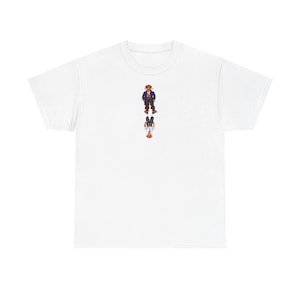 Könnte beinhalten: Weißes T-Shirt mit einer farbenfrohen Illustration einer Person, die aufrecht über ihrer Spiegelung steht. Die Person trägt eine braune Jacke, blaue Hose und ein rotes Hemd. Die Spiegelung spiegelt die Kleidung der Person wider.