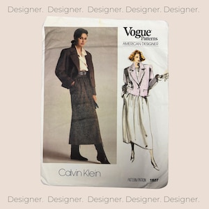 May include: A vintage sewing pattern for a skirt and jacket designed by Calvin Klein. The pattern is from Vogue Patterns, American Designer, and the pattern number is 1627.