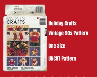 May include: Vintage McCall's Crafts sewing pattern P320 for holiday crafts. The pattern includes instructions for making a bear Christmas ornament, a stocking, a star, and an angel. The pattern is uncut and one size.